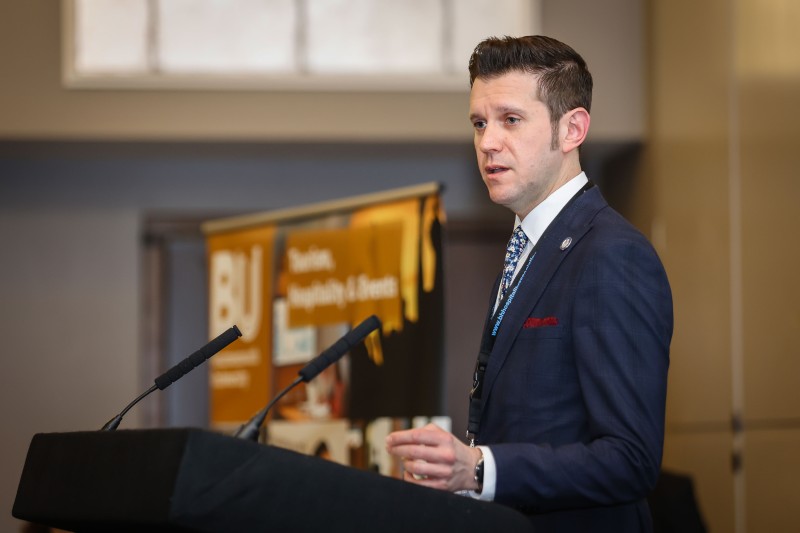 Robert Richardson standing at a lectern speaking