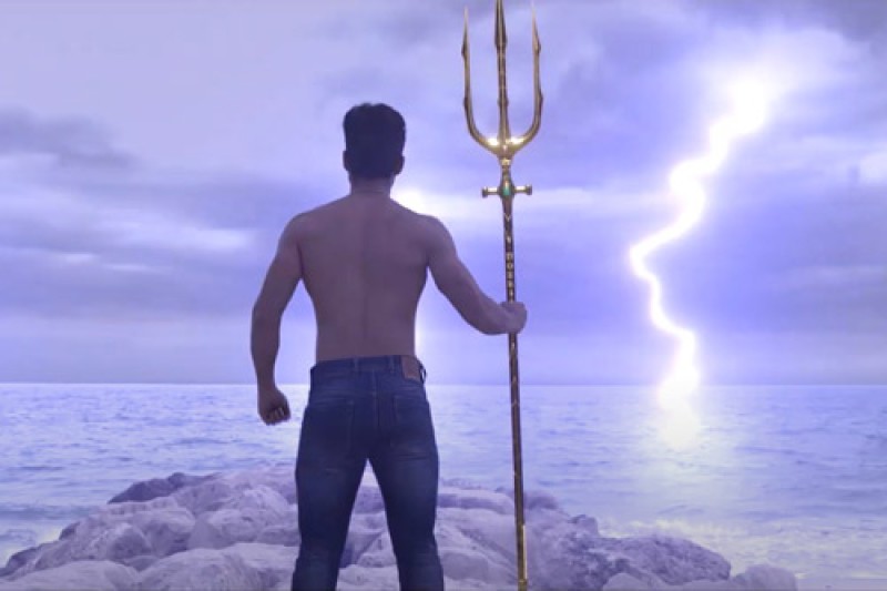 Houdini Computer animation showing the back of a man holding a trident, looking out to sea with a striking in the background