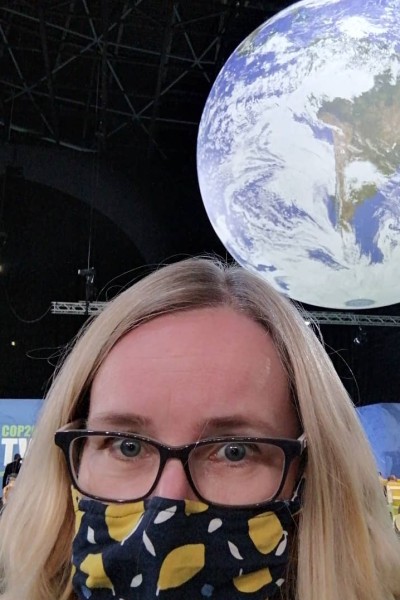 Emma Jenkins at COP26 with a globe behind her 
