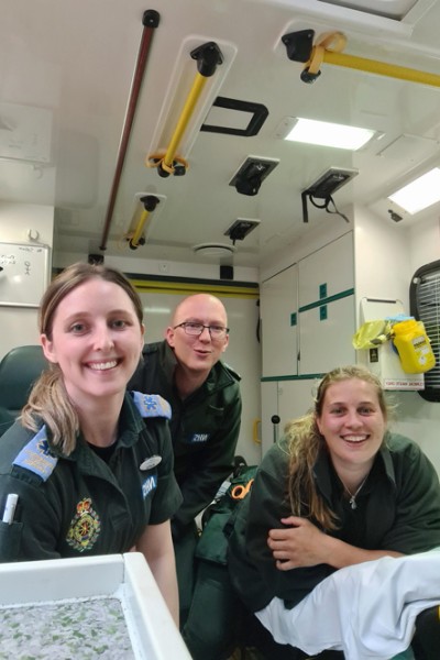 Kelly Bateman is pictured with her colleagues in the back of an ambulance