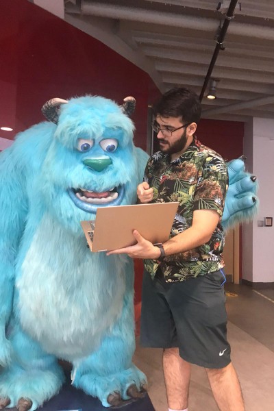 Jamie Howatson, a Bournemouth University graduate, with a life-size Sulley from Monsters, Inc. on BU's Talbot Campus.