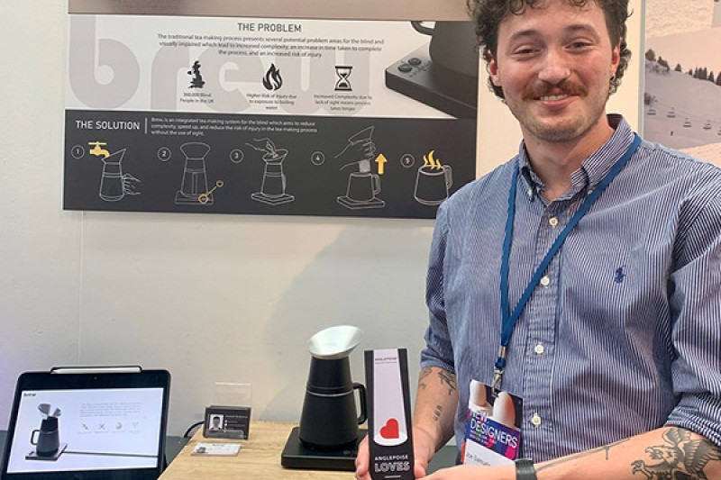 Joe and his award next to prototype of Brew Joe holds his award next to a prototype of his tea making system for blind and partially sighted people