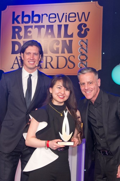 Rini Vanchhawng, BU graduate, collecting her Rising Star of the Year at the kbbreview Retail & Design Awards 2022, alongside host Vernon Kay and Stephen Johnson of Quooker presenting the award 