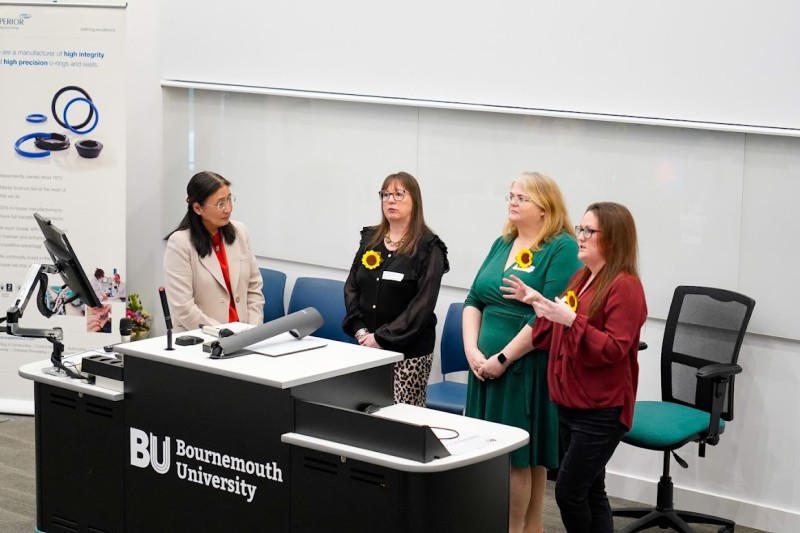 Professor Bee Wee and the three female BU grads standing at the front of the lecture theatre talking