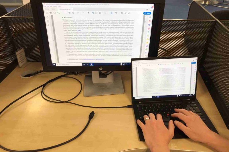 New library screens A laptop plugged into a monitor, so both screens are useable