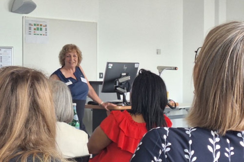 Liz Dominey Liz Dominey talking to a group of women sitting at a table