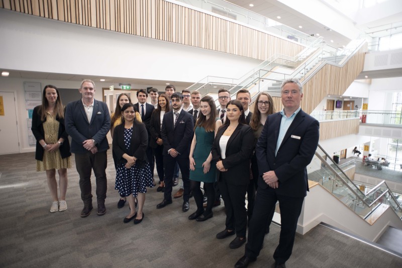 A photograph of Business Management students gathered with representatives of the Ministry of Defence in the BGB building