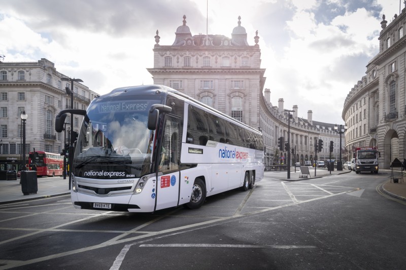 National Express coach travelling through a town centre