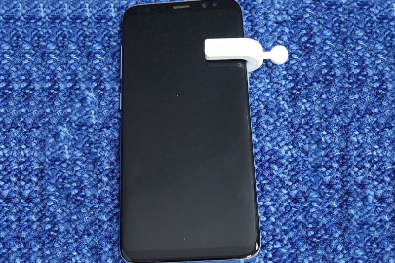 A smartphone with the NERVE device attached 