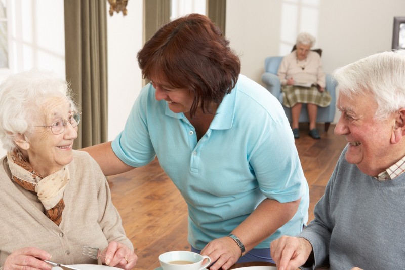 Older people served dinner by a carer Older people served dinner by a carer