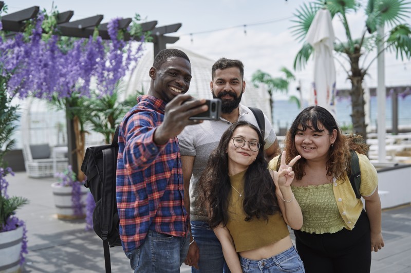Students taking selfie on beach