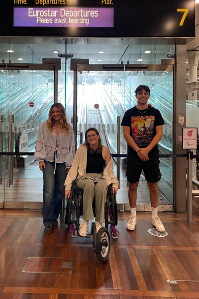 Three students at the Eurostar terminal, looking at the camera smiling