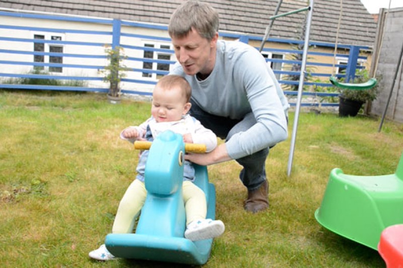 Father with child playing in garden