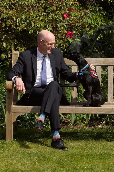 Peter Aiers sitting on a bench with his dog