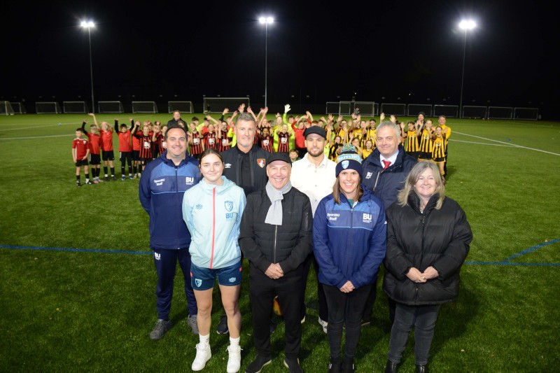 Holly Humphreys (front row, left) and Emiliano Marcondes (second row, second from right) with AFC Bournemouth youth teams and BU representatives at the opening of the Chapel Gate multi-sports community pitch in November 2023