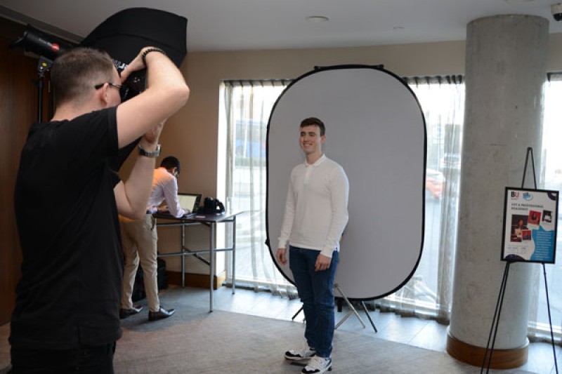 A stand offering professional photographs for potential candidates at the exhibition