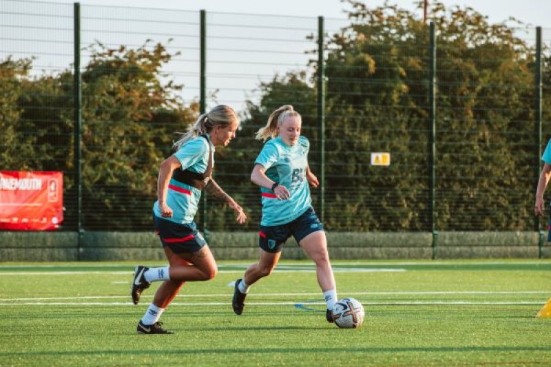 women playing football