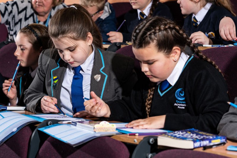 Local school children taking part in a Books and Stories activity in one of BU's lecture theatres