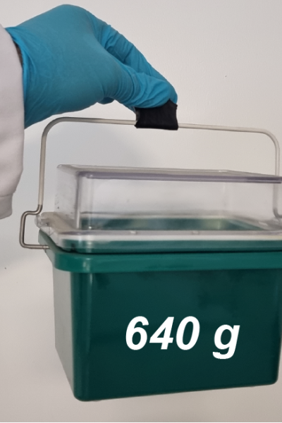 The plastic strip wrapped around the handle of a bucket, holding it in the air. The bucket is labelled "640 grammes"