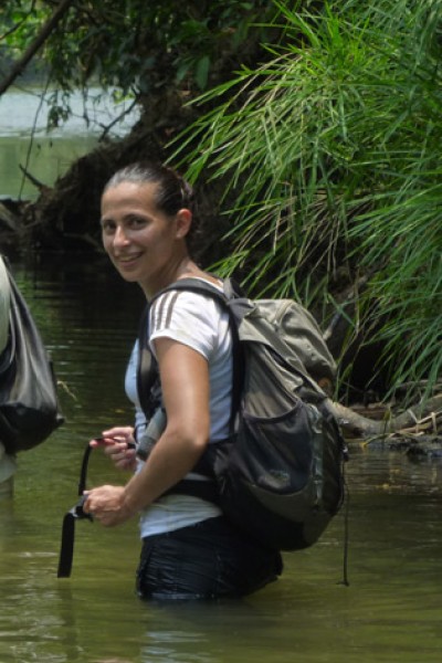 Dr Shedden standing in a river on a field trip