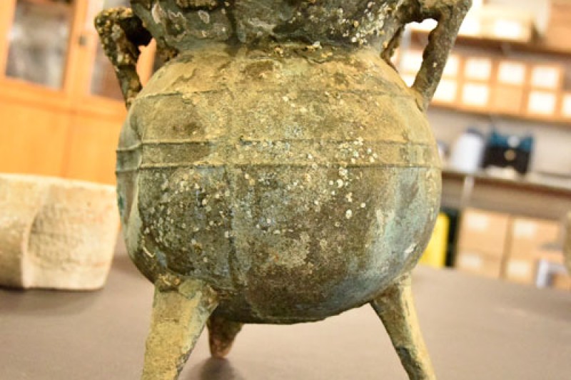 A picture of a couldron on a table, used to cook with by the crew of the ship at sea