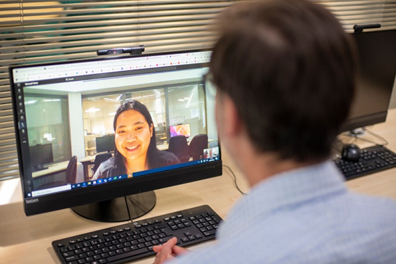 staff and student talking via laptop