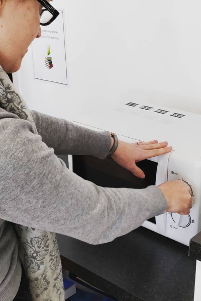 student using a microwave