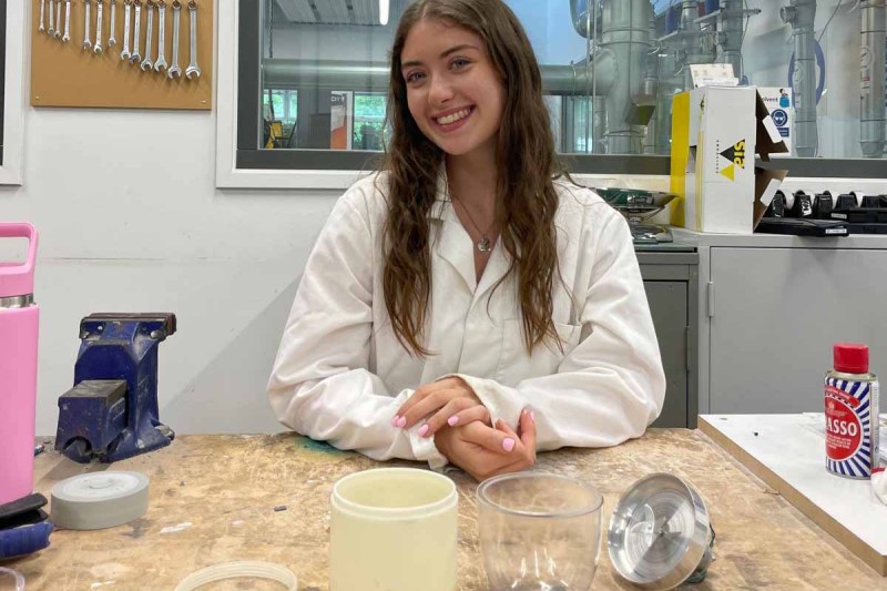 Sophie in the workshop with the components of her product in front of her