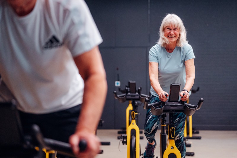A CHAIN participant on a static bike during a class