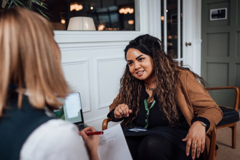 women listening to her colleague during a meeting