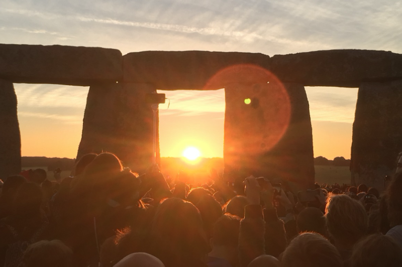 A crowd of people at Stonehenge for the sunrise