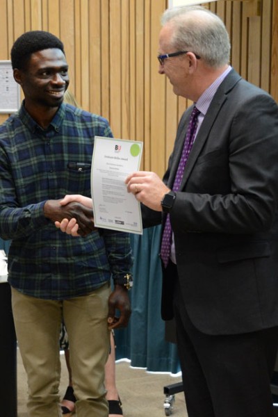 BU student receiving his award from Vice-Chancellor Professor John Vinney
