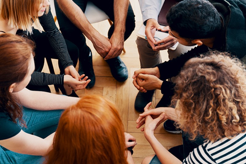 Close up of a group of people attending a counselling session