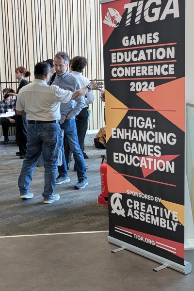 A banner with the TIGA logo on.