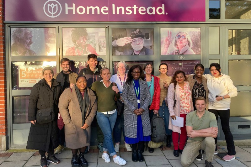 Gladys Yinusa with staff from Home Instead outside one of their offices