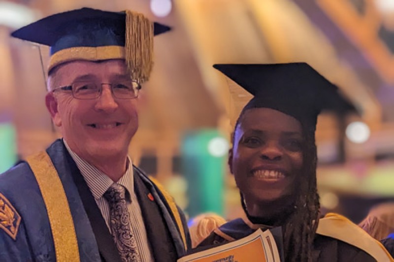 Professor John Vinney and Affi Bassey in their graduation gowns