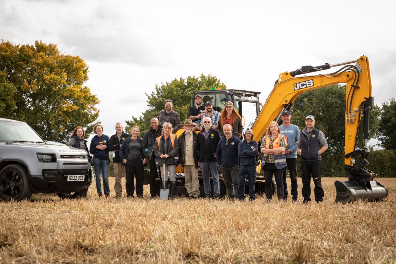 Time Team presenting crew surrounding a digger
