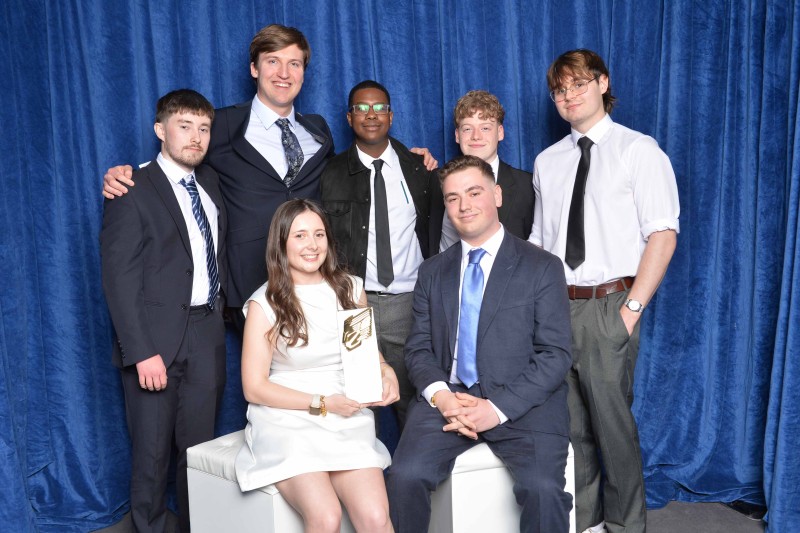 A group shot of the students holding their award