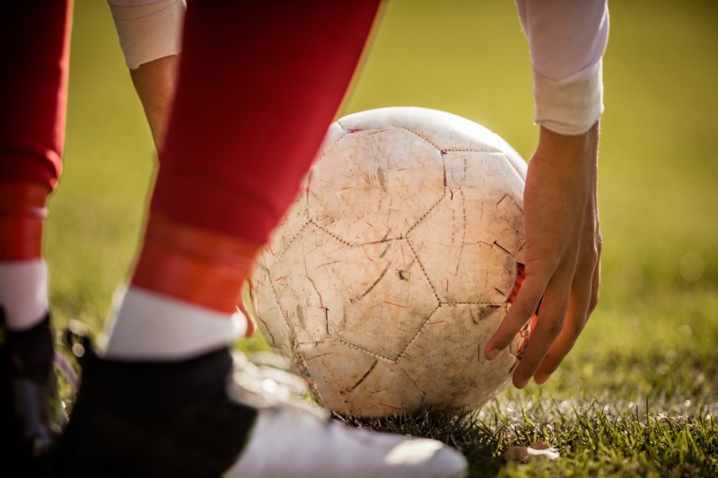 Close up of a ball being placed on the pitch Close up of a ball being placed on the pitch