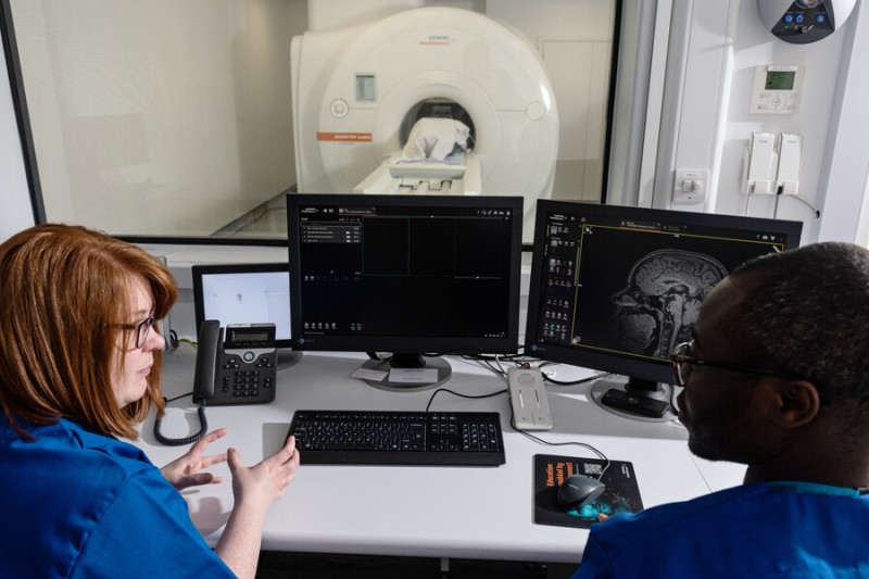 BU students with computers and MRI scanner in the background