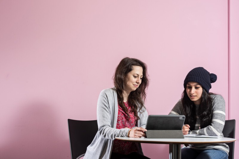 Two students looking at a laptop