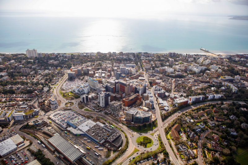 An aerial shot of Bournemouth, capturing much of the town, with the beach and sea on the horizon