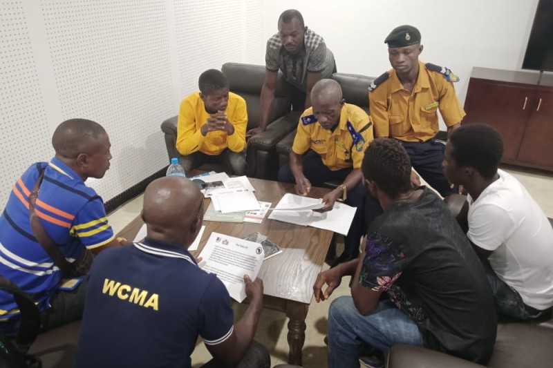 Local authority staff and emergency service workers sitting at a table, discussing the disaster management procedures