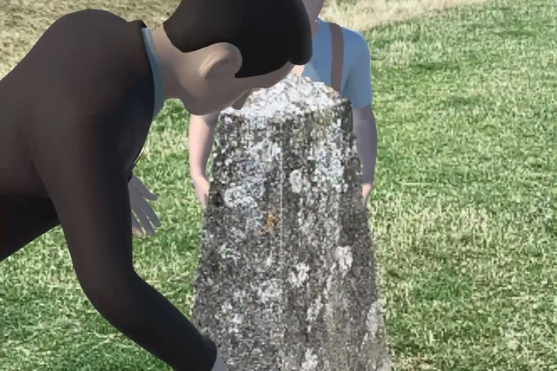 An augmented reality view on a mobile phone screen showing a real stone with animated images of two people around it. 