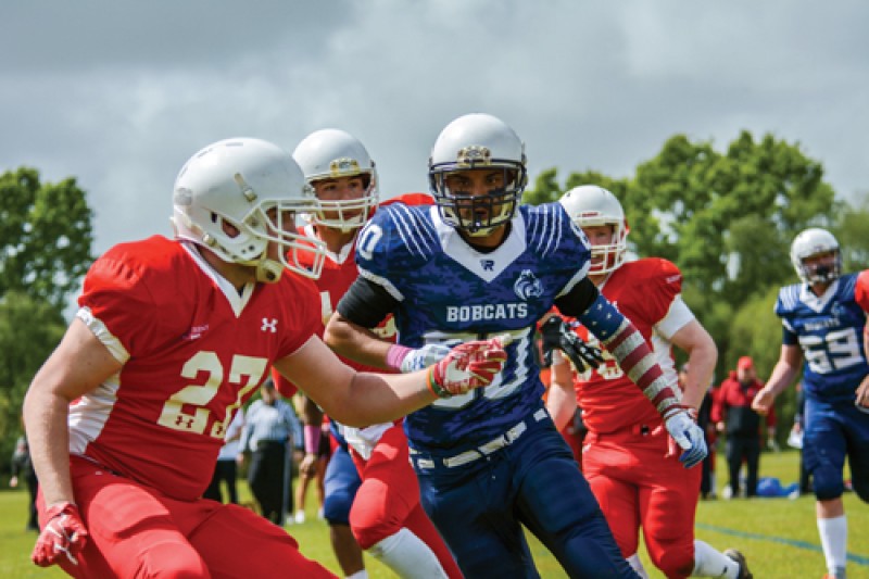 A Bobcats player running at the opposition during the 2019 Varsity match against Solent University