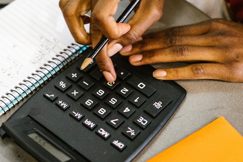 Finance - person using calculator Finance - person using calculator