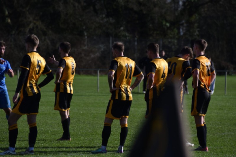 Image of five football players dressed in gold and black