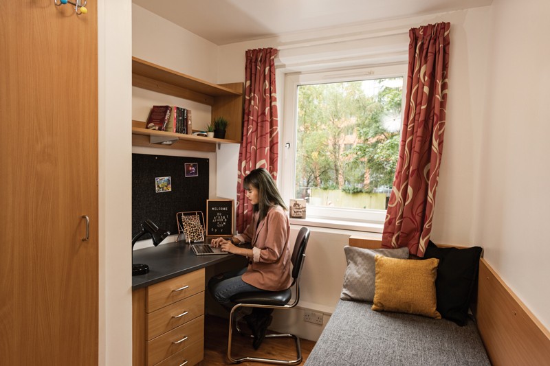 A student working at their desk in a room in Cranborne House