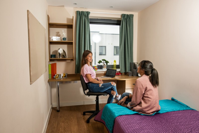 Two students talking in a Dorchester House bedroom