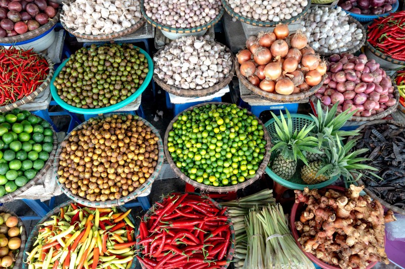 Different baskets of fruit and vegetables on display at a market